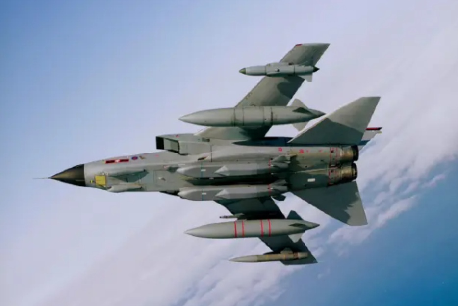 Gray Tornado fighter jet flying in a clear blue sky.
