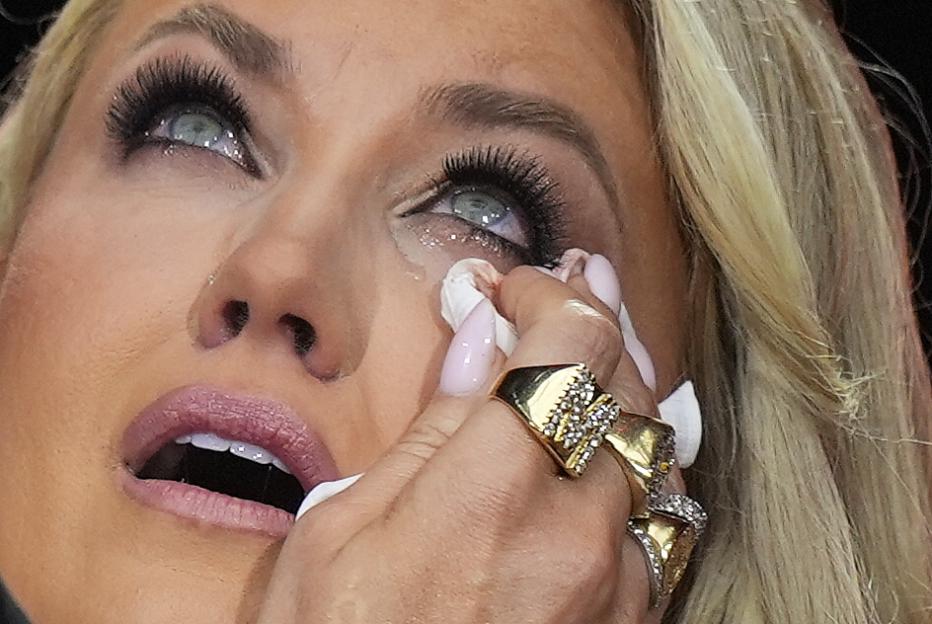 Erika Kirk wipes tears at a memorial for her husband, Charlie Kirk.