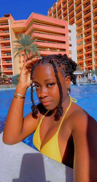 Woman in yellow bikini by a pool.
