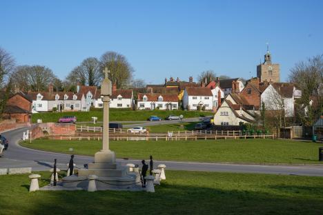 View of Finchingfield village in Essex, England, with a war memorial in the foreground.