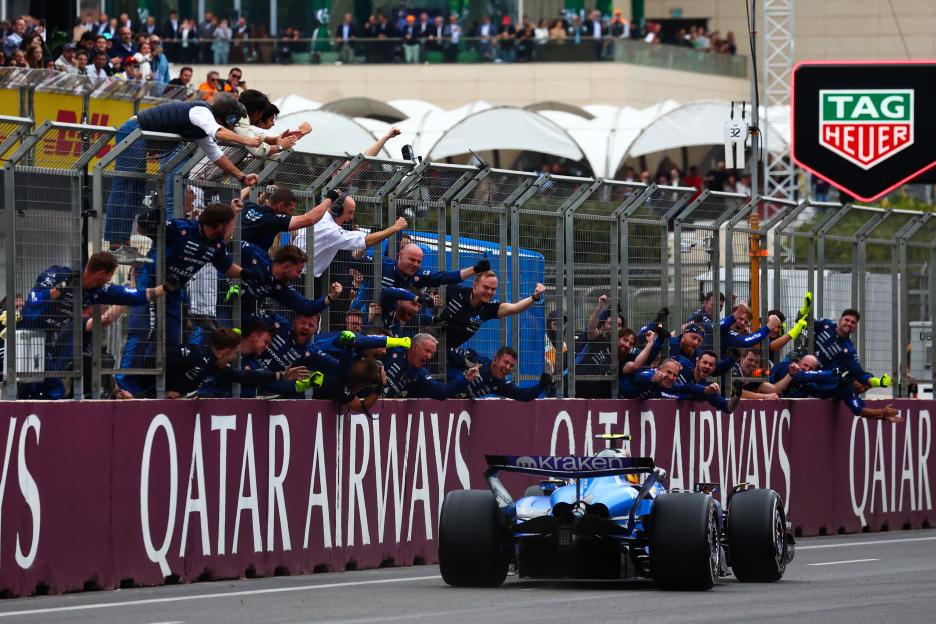 The Williams FW47 Mercedes, driven by Carlos Sainz, passes his cheering team on the pit wall at the F1 Grand Prix of Azerbaijan.