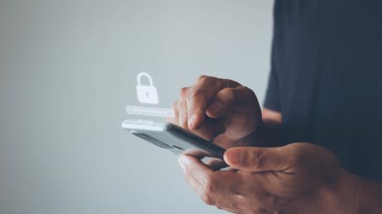 Person using a smartphone to enter a password.