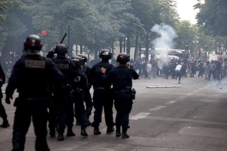 Police officers clash with a crowd.