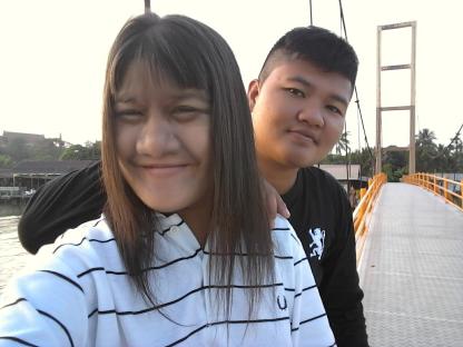 Selfie of a young couple on a bridge.