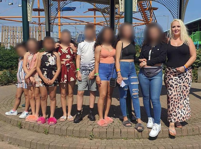 A group of people posing for a picture with their faces blurred