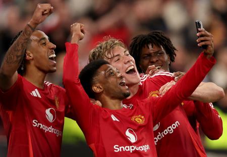 Manchester United players celebrating and taking a selfie.