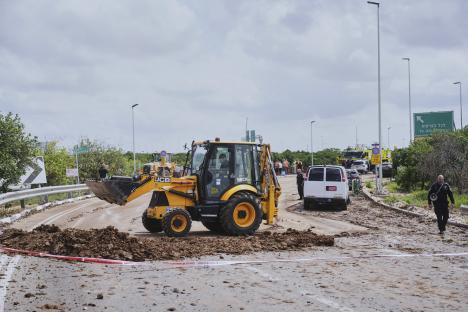 Israeli security forces clearing debris from a road near Ben Gurion Airport.