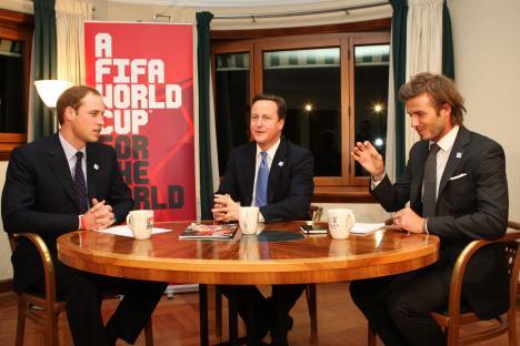 Prince William, David Beckham, and David Cameron seated at a table.
