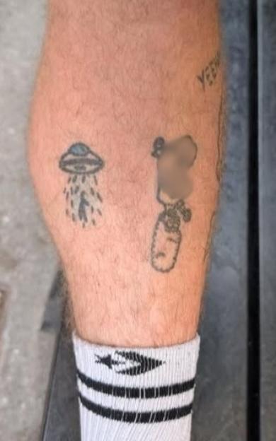 Person's lower leg with several small tattoos.