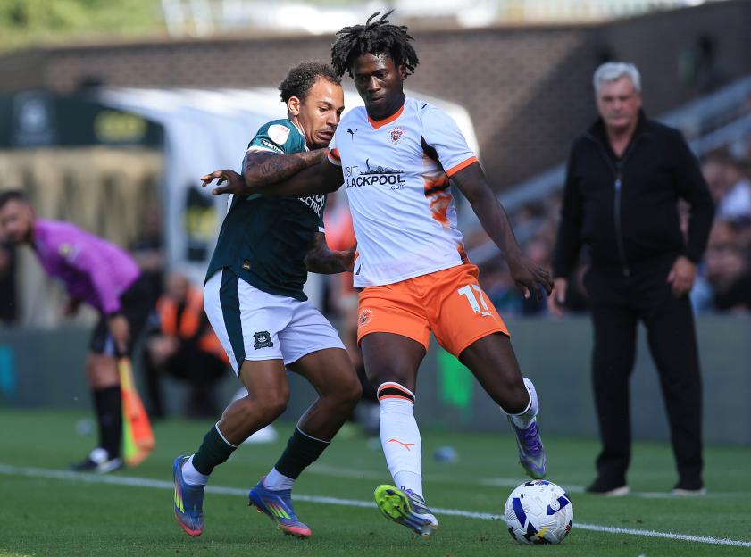 Soccer players battling for the ball.