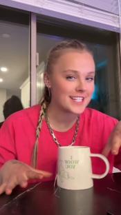 Jojo Siwa holding a mug.