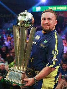 Luke Littler holding a PDC World Darts Championship trophy.