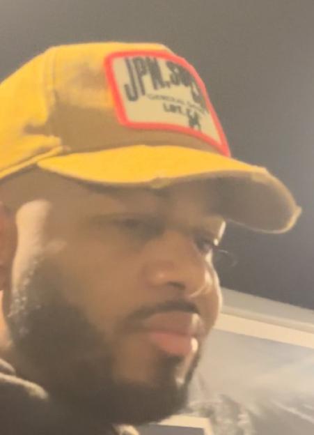 Man wearing a yellow cap with a patch that says "JPN.SUG." and "GENERAL STORE LA"