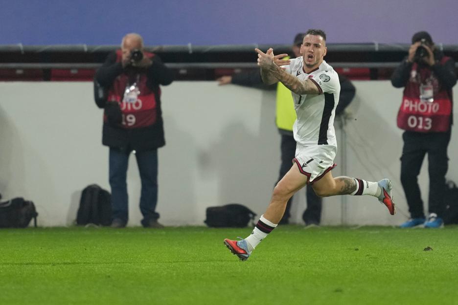 Albania's Rey Manaj celebrates scoring a goal during a soccer match.