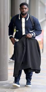 Micah Richards carrying a jacket.
