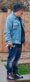 Surveillance image of a man in a denim jacket.