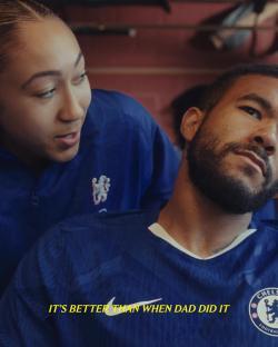 Woman and man in Chelsea kit.