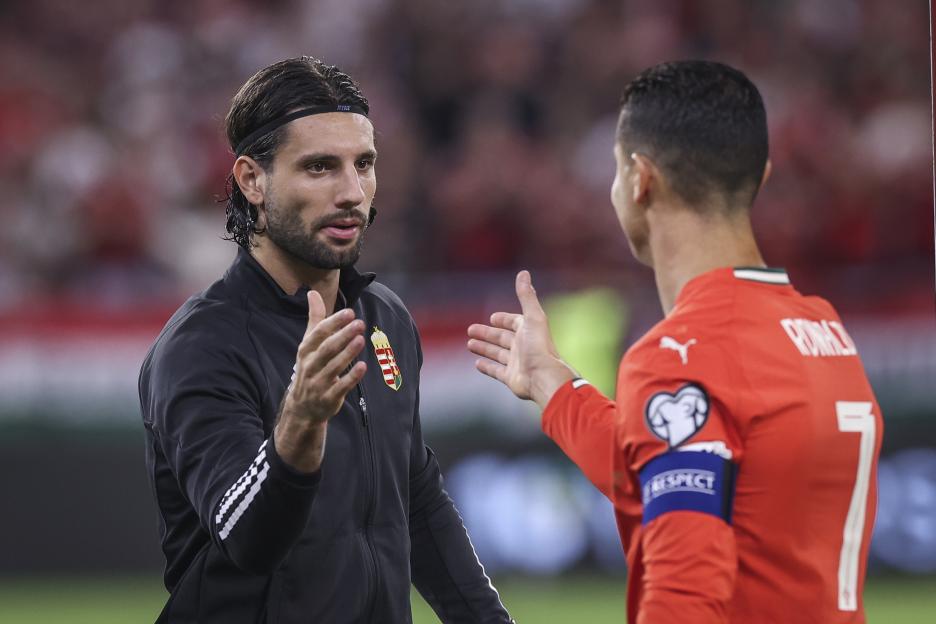 Dominik Szoboszlai and Cristiano Ronaldo talking before a soccer match.