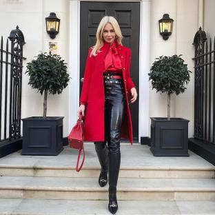 Woman in red coat and black leather pants.