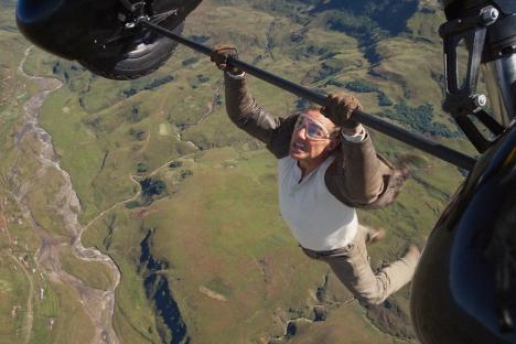 Tom Cruise hanging from a helicopter in Mission: Impossible - Dead Reckoning.