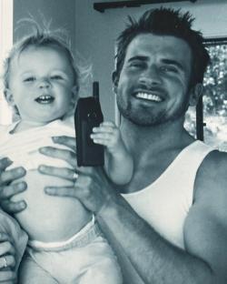 Black and white photo of a man holding a toddler.