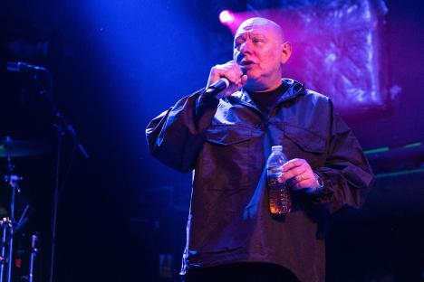 Shaun Ryder of Black Grape performing on stage.
