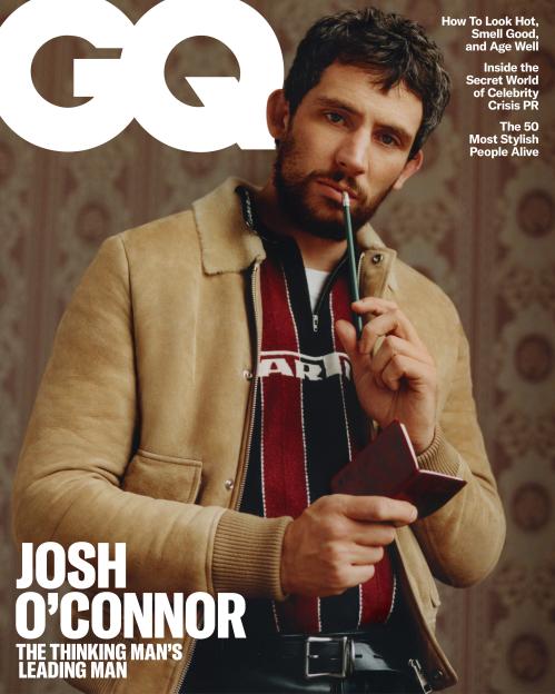 GQ magazine cover featuring Josh O'Connor with a pencil in his mouth, wearing a beige jacket and a striped shirt.