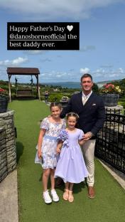 A man with two young girls on Father's Day.