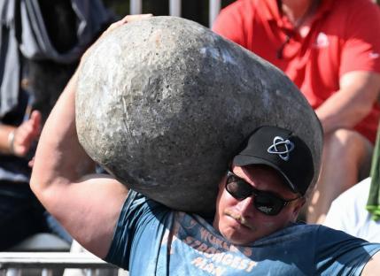 Rayno Nel of South Africa performs the stone to shoulder press in the Natural Stone Medley during the qualifying round of the