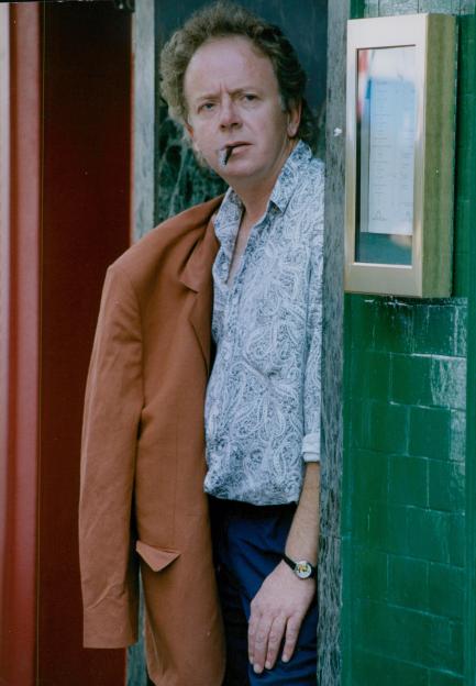Photo of actor Ray Brooks smoking a cigarette.