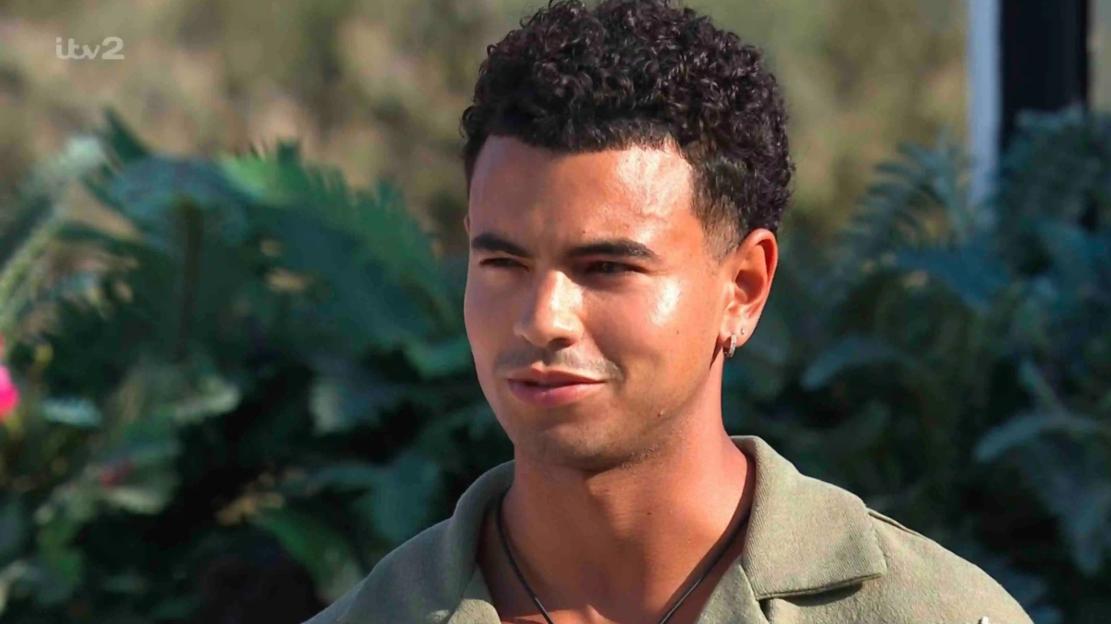 Headshot of a man with curly hair.
