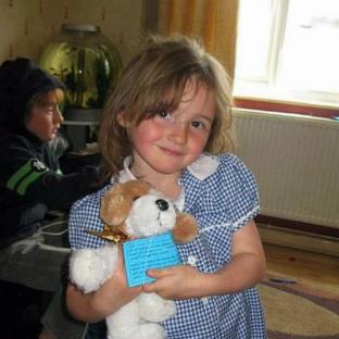 Photo of April Jones, a five-year-old girl, holding a stuffed dog.
