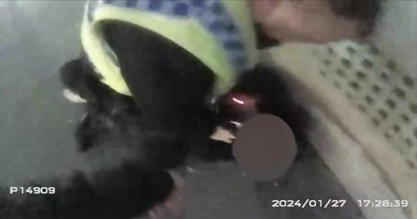Video still of a police officer making an arrest.