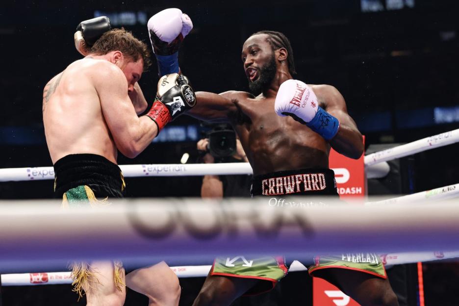 LAS VEGAS, NEVADA - SEPTEMBER 13: Terence Crawford (blue gloves) punches Canelo Alvarez (red gloves) for the Undisputed & Ring Magazine Super Middleweight Championship at Allegiant Stadium on September 13, 2025 in Las Vegas, Nevada. (Photo by Ed Mulholland/TKO Worldwide LLC via Getty Images)