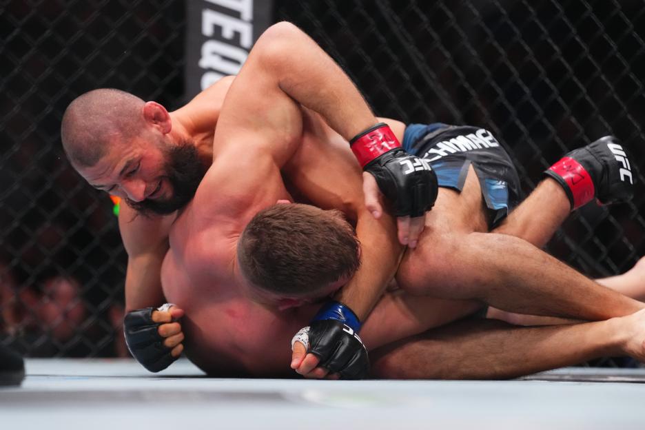 Khamzat Chimaev of Russia controlling Dricus du Plessis of South Africa during a UFC match.