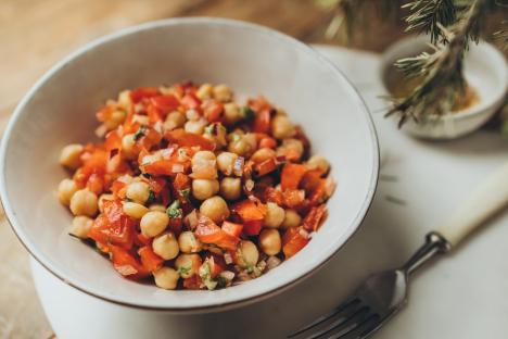 Chickpea salad with tomatoes in a bowl.