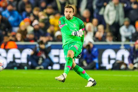 Tim Krul of Luton Town kicking a soccer ball during a match.