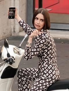 Lily Collins on a scooter, taking a selfie.