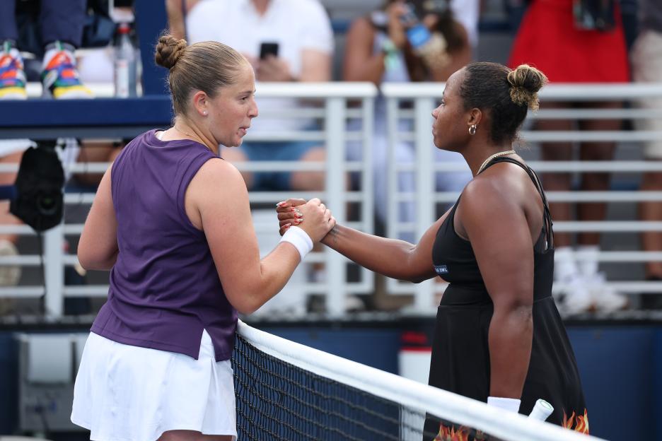 Taylor Townsend and Jelena Ostapenko shaking hands at the net after a tennis match.