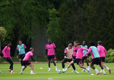 Chelsea players in pink training kits practicing at Cobham Training Ground.