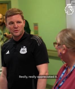 Man in Newcastle United shirt thanking a woman.