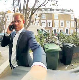 Prince Harry on a phone call, knocking on a door in Fulham.