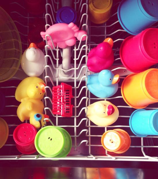 Dishwasher with various items inside for cleaning.