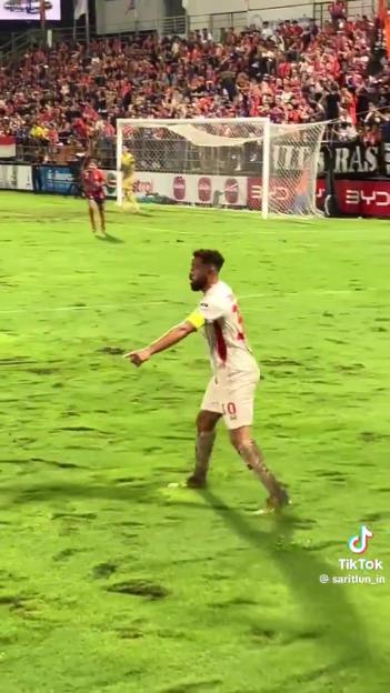 Andros Townsend on a soccer field after scoring a goal.