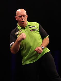 Michael van Gerwen celebrating at a darts match.