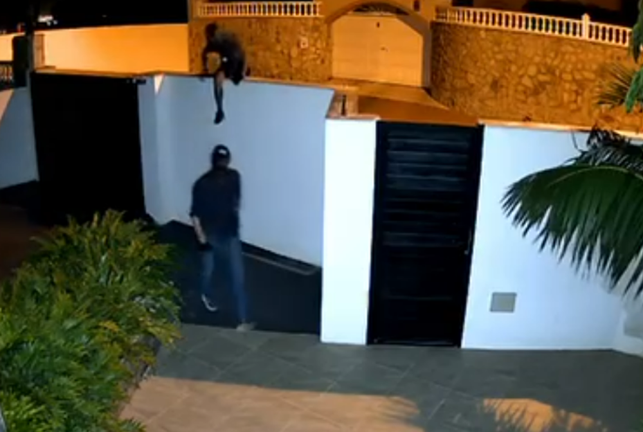 Security camera footage of a robbery in progress.