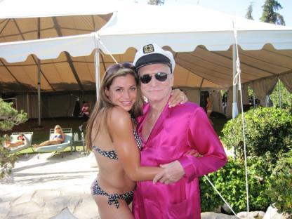 Hugh Hefner with a woman in a bikini.