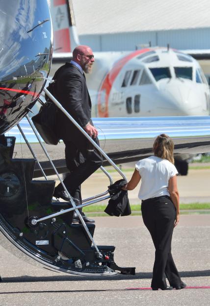 Triple H and Stephanie McMahon arriving at an airport.
