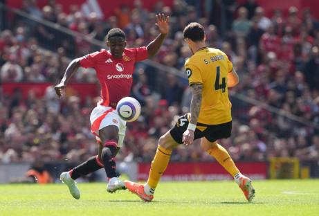 Manchester United's Kobbie Mainoo (left) and Wolverhampton Wanderers' Santiago Bueno battle for the ball during the Premier League match at Old Trafford, Manchester. Picture date: Sunday April 20, 2025. PA Photo. See PA story SOCCER Man Utd. Photo credit should read: Martin Rickett/PA Wire. RESTRICTIONS: EDITORIAL USE ONLY No use with unauthorised audio, video, data, fixture lists, club/league logos or "live" services. Online in-match use limited to 120 images, no video emulation. No use in betting, games or single club/league/player publications.