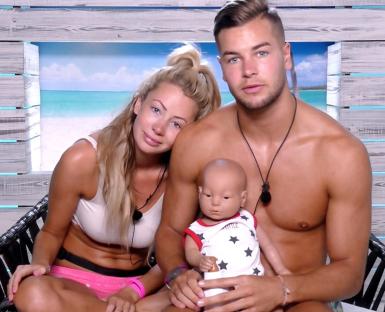 Olivia Attwood and Chris Hughes from Love Island holding a baby doll.